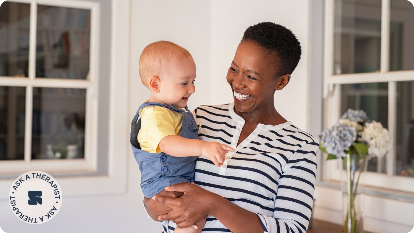 black woman smiling at baby she is holding